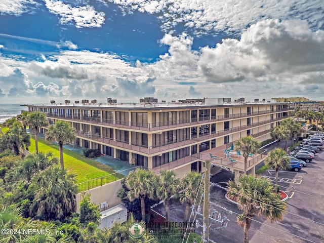 view of building exterior with a water view and fence