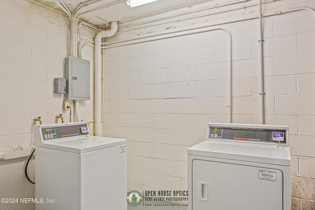 laundry area featuring laundry area, washing machine and dryer, and electric panel