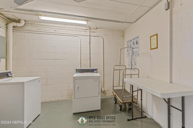 community laundry room featuring independent washer and dryer and concrete block wall