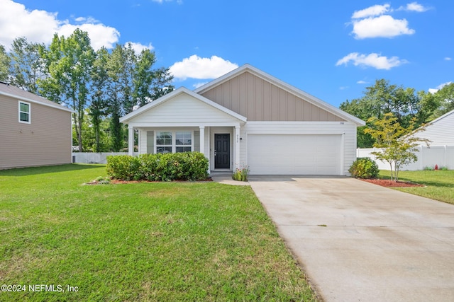 view of front of property with a garage and a front lawn