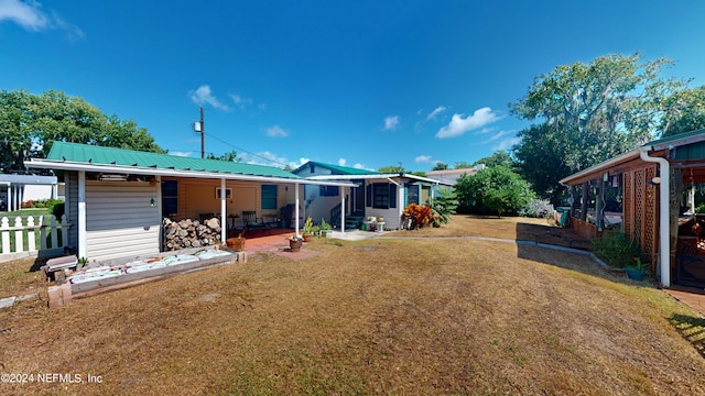 rear view of house featuring a patio and a lawn