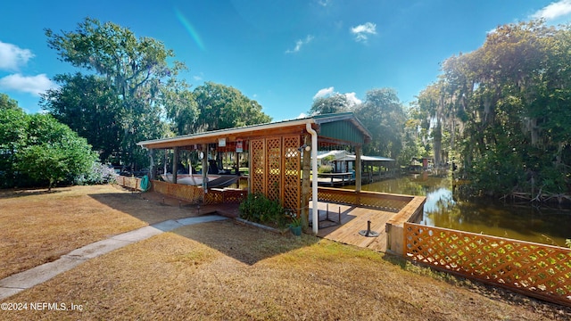 view of front of home with a boat dock and a water view