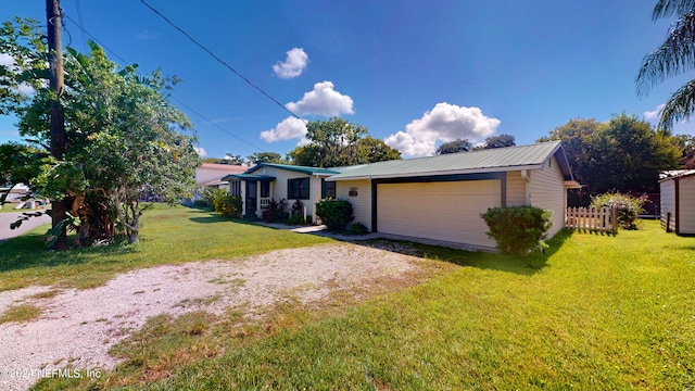 view of front of property with a garage and a front lawn