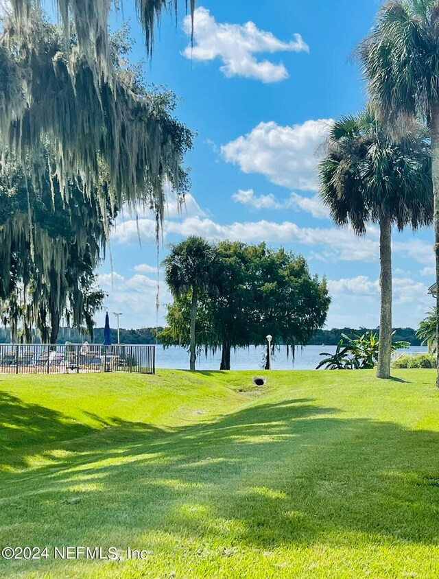 view of home's community featuring a yard and a water view