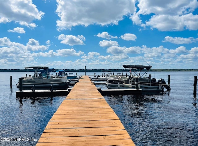 dock area with a water view and boat lift