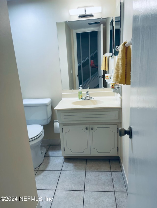 bathroom featuring tile patterned floors, toilet, and vanity