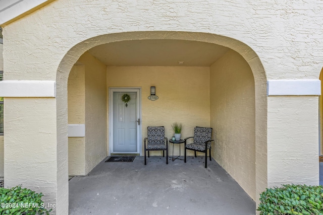 doorway to property with stucco siding