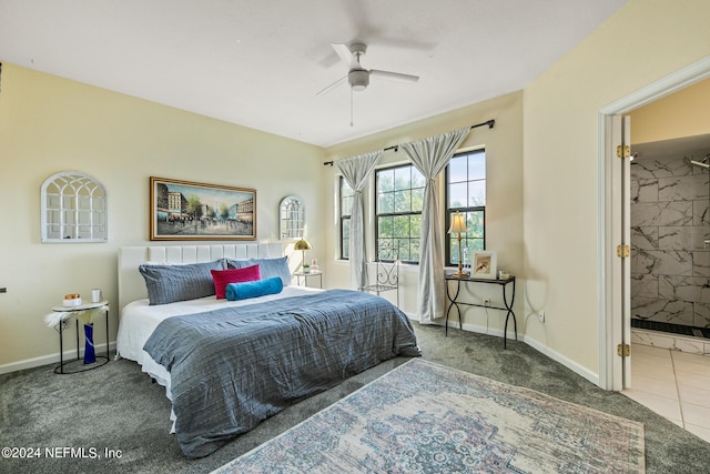 carpeted bedroom with ensuite bathroom and ceiling fan