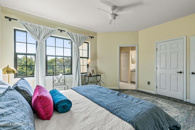 bedroom with carpet, baseboards, a ceiling fan, and ensuite bathroom