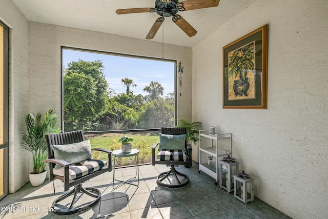 sunroom featuring ceiling fan and plenty of natural light