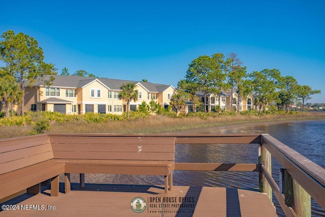 dock area featuring a water view and a residential view