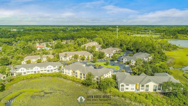 drone / aerial view with a water view, a forest view, and a residential view