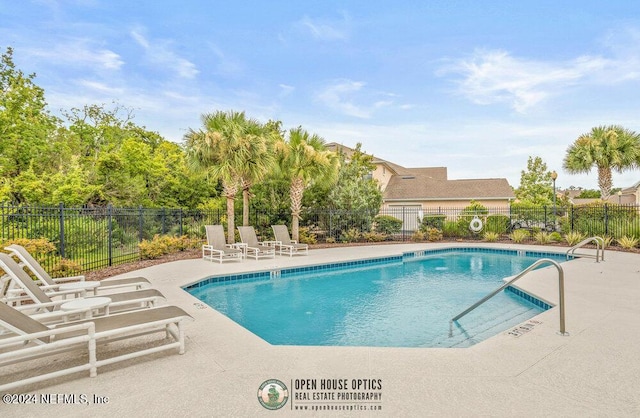 pool featuring a patio area and fence