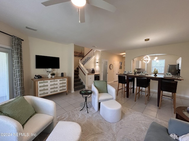 living room with ceiling fan and light tile patterned flooring