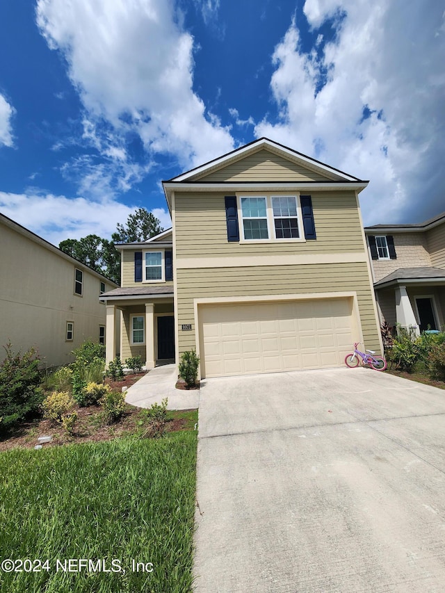 view of front of property with driveway and a garage