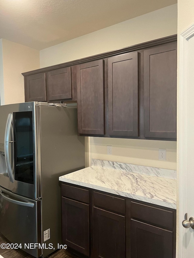 kitchen with dark brown cabinetry and smart refrigerator