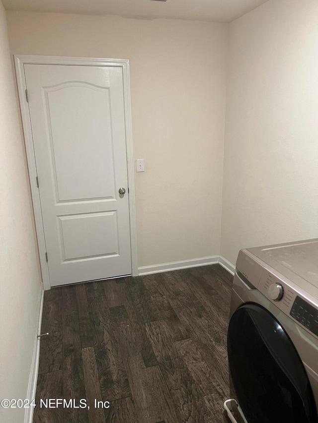 washroom with laundry area, washer / clothes dryer, dark wood-type flooring, and baseboards