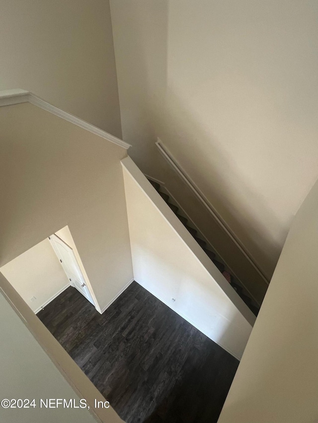 stairway featuring wood finished floors