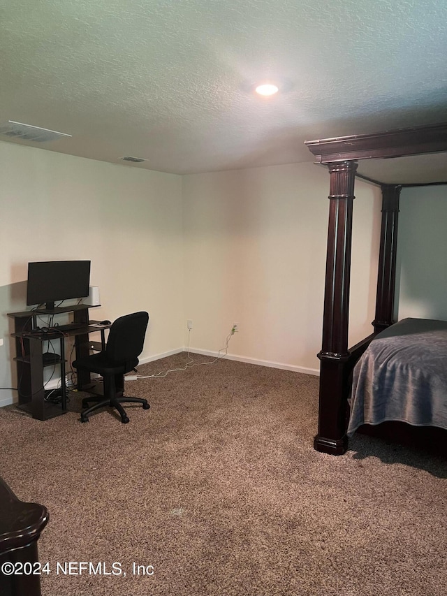 interior space featuring a textured ceiling, carpet flooring, visible vents, and baseboards