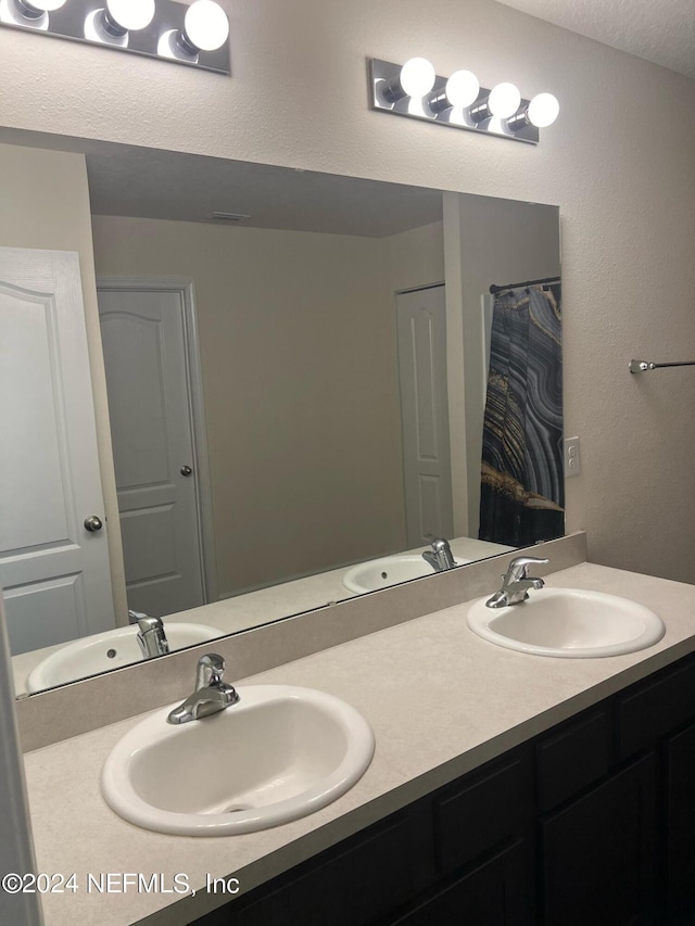 bathroom featuring double vanity and a sink