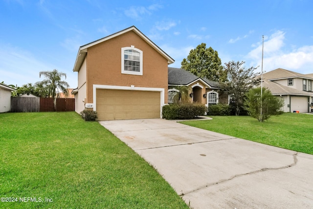 view of property featuring a garage and a front lawn