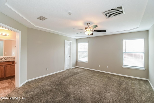 carpeted spare room featuring ceiling fan