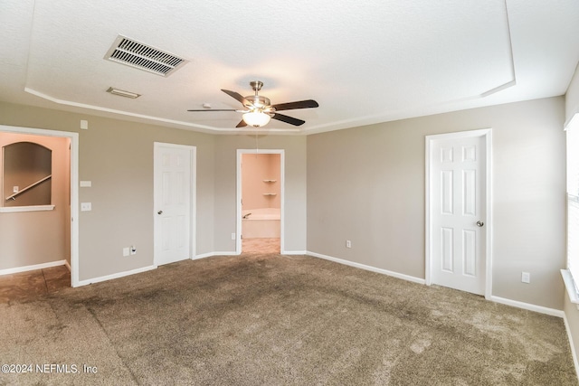 unfurnished bedroom with ceiling fan, connected bathroom, and carpet floors