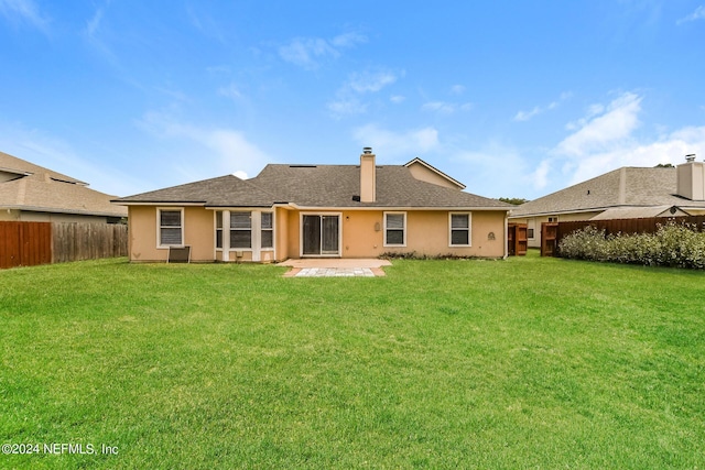 rear view of house with a lawn