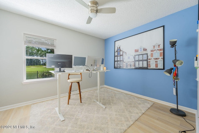 office with a textured ceiling, hardwood / wood-style flooring, and ceiling fan