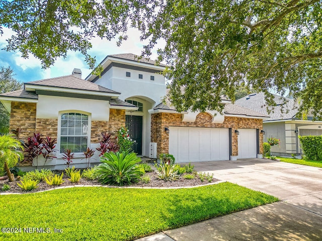 view of front facade with a front yard and a garage