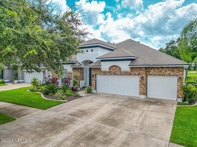 view of front of house with a garage and a front lawn