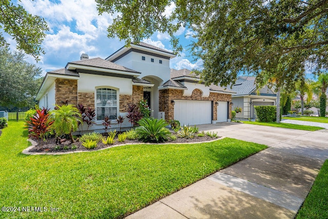 view of front facade featuring a front yard and a garage