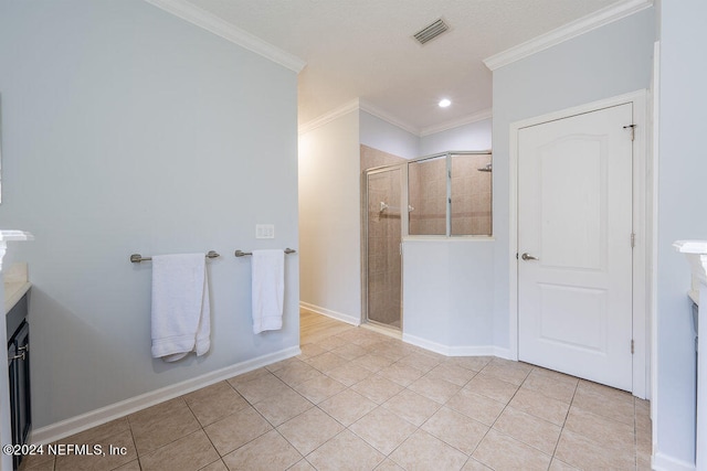 bathroom with vanity, ornamental molding, walk in shower, and tile patterned flooring