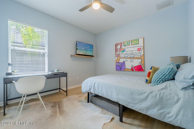 bedroom with ceiling fan and wood-type flooring