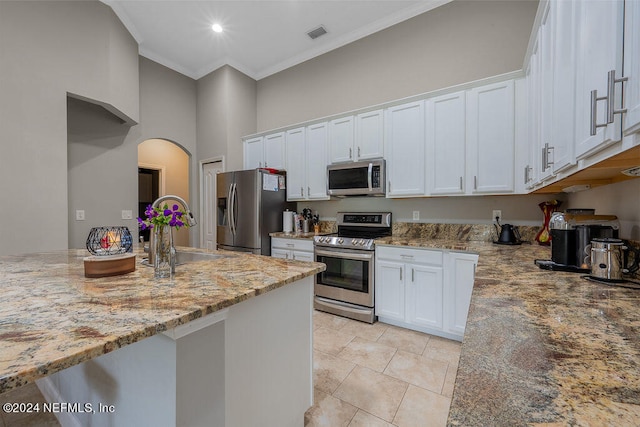 kitchen featuring stainless steel appliances, sink, crown molding, white cabinetry, and light stone counters