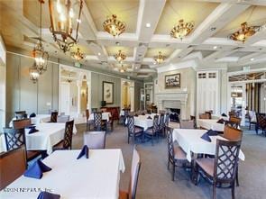 dining space featuring beam ceiling and coffered ceiling