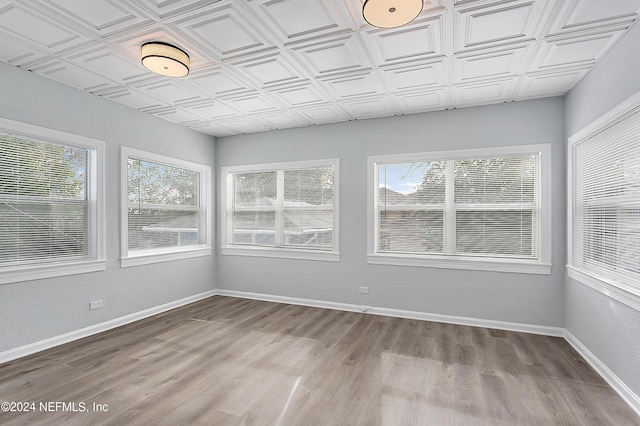 unfurnished sunroom featuring plenty of natural light and an ornate ceiling