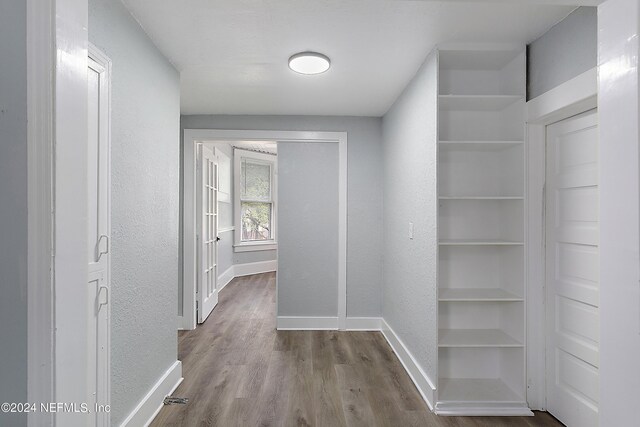 hall with wood-type flooring