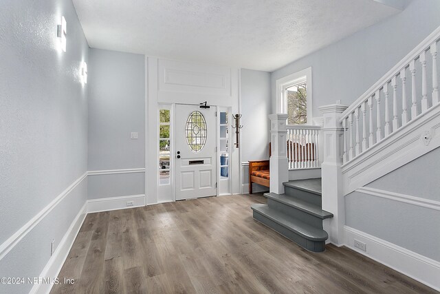 entrance foyer with a textured ceiling and hardwood / wood-style flooring