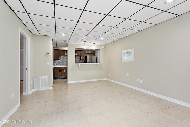 interior space with light tile patterned flooring, recessed lighting, visible vents, and baseboards