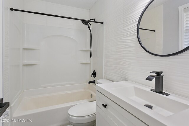 full bathroom with tile walls, vanity, bathing tub / shower combination, and toilet