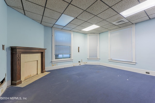 below grade area featuring baseboards, visible vents, and a drop ceiling