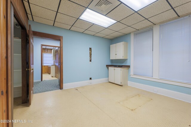 empty room featuring a paneled ceiling