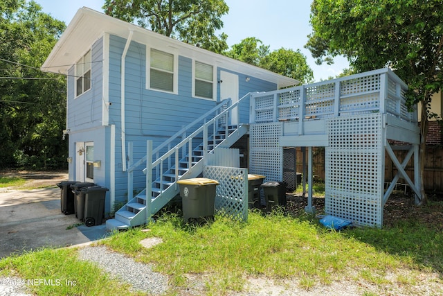 back of house with driveway and stairway