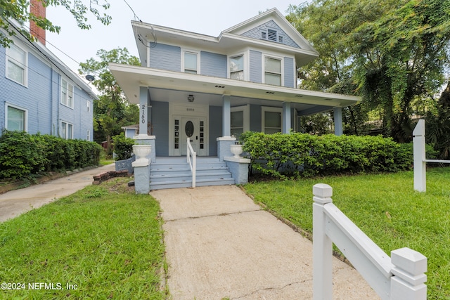 view of front of home with a front lawn and covered porch