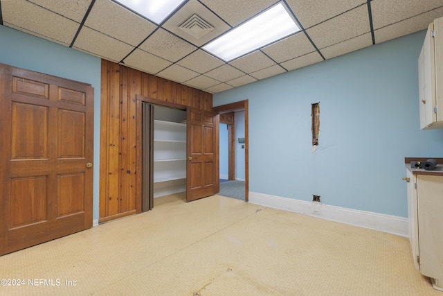 interior space with baseboards, a closet, visible vents, and a drop ceiling