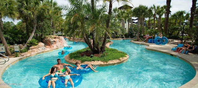 view of swimming pool featuring a water play area