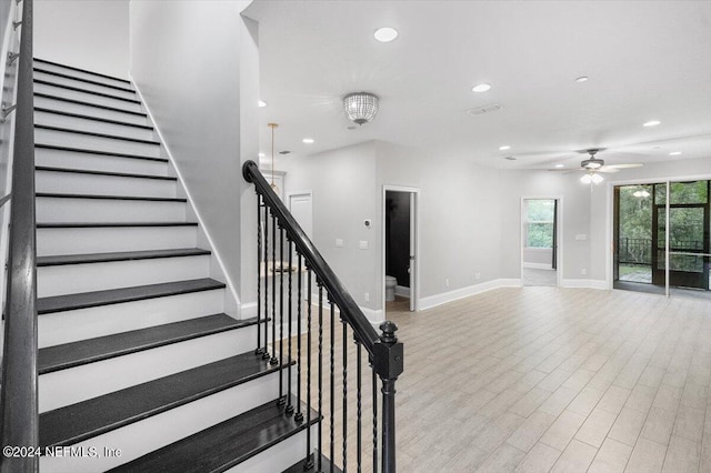 stairs with baseboards, ceiling fan, wood finished floors, and recessed lighting