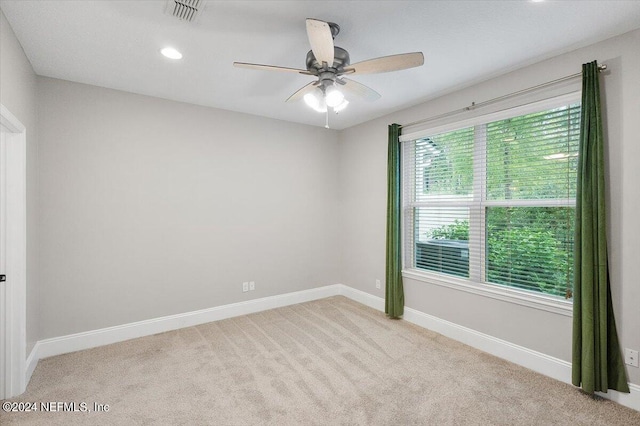 spare room with ceiling fan, recessed lighting, carpet flooring, visible vents, and baseboards