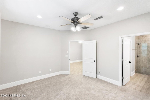 unfurnished bedroom featuring light carpet, visible vents, and recessed lighting